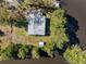 An aerial view of house's roof, surrounded by lush greenery and a lake at 5275 Miller Bayou Dr, Port Richey, FL 34668