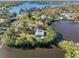 Waterfront property with lush landscaping, dock, and panoramic views of the surrounding bay and neighborhood at 5275 Miller Bayou Dr, Port Richey, FL 34668