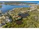 Aerial view of a waterfront home on a secluded lot with mature trees at 5275 Miller Bayou Dr, Port Richey, FL 34668
