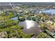 Overhead view of lakeside home featuring a dock and waterfront, nestled amidst lush trees and scenic views at 5275 Miller Bayou Dr, Port Richey, FL 34668