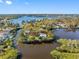 Captivating aerial view of a home enveloped by lush greenery and serene waters, showcasing its tranquil setting at 5275 Miller Bayou Dr, Port Richey, FL 34668