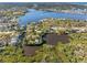 Beautiful aerial view overlooking peaceful neighborhood on a calm waterway, showcasing lush green surroundings at 5275 Miller Bayou Dr, Port Richey, FL 34668