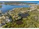 Aerial view of a waterfront home on a secluded lot with mature trees at 5275 Miller Bayou Dr, Port Richey, FL 34668