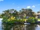 Charming waterfront home with private dock surrounded by lush greenery and serene water views at 5275 Miller Bayou Dr, Port Richey, FL 34668