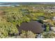 Breathtaking aerial of a lake and waterfront property surrounded by wetlands, with nearby community at 5275 Miller Bayou Dr, Port Richey, FL 34668