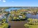Aerial view of a waterfront home surrounded by mature trees and stunning water views at 5275 Miller Bayou Dr, Port Richey, FL 34668