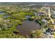 Overhead view of a lakeside house with dock access, set amid beautiful greenery and scenic waterfront views at 5275 Miller Bayou Dr, Port Richey, FL 34668