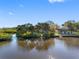 Bayfront home features lush greenery, private dock, and access to open waterways for boating and recreation at 5275 Miller Bayou Dr, Port Richey, FL 34668