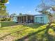 Backyard view with screened-in patio and gazebo at 5275 Miller Bayou Dr, Port Richey, FL 34668