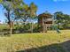 Outdoor play area featuring a treehouse with slide and a swing set at 5275 Miller Bayou Dr, Port Richey, FL 34668