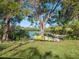 Lush backyard featuring a hammock, kayak, mature trees, and waterfront views at 5275 Miller Bayou Dr, Port Richey, FL 34668