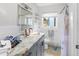 Bathroom features granite countertops, framed mirror, and a shower/tub combination at 5275 Miller Bayou Dr, Port Richey, FL 34668