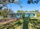 The lovely home showcases a well-kept lawn, carport, and cozy front porch at 5275 Miller Bayou Dr, Port Richey, FL 34668