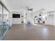 Open-concept living space with tile flooring, ceiling fan, and kitchen area at 5275 Miller Bayou Dr, Port Richey, FL 34668