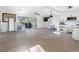 Bright living room features tile flooring, sliding glass doors to the lanai, and an open concept to the kitchen at 5275 Miller Bayou Dr, Port Richey, FL 34668