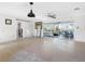 Open living room with large sliding glass doors, tile floors, and access to the kitchen at 5275 Miller Bayou Dr, Port Richey, FL 34668