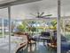 Enclosed sunroom features a ceiling fan and scenic water views at 5275 Miller Bayou Dr, Port Richey, FL 34668