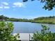 Expansive waterfront view featuring calm waters, lush green trees and vegetation, ideal for relaxation at 5275 Miller Bayou Dr, Port Richey, FL 34668
