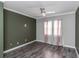 Bedroom featuring wood floors, a ceiling fan and curtains covering a window at 13794 Marseilles Ct, Clearwater, FL 33762