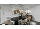 Well-lit dining room with a dark wood table, six chairs, and modern pendant lighting at 13794 Marseilles Ct, Clearwater, FL 33762