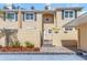 Townhome exterior showcasing a well-manicured facade, including a paver walkway and neat landscaping at 13794 Marseilles Ct, Clearwater, FL 33762
