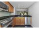 Modern kitchen featuring wood cabinets, stainless steel appliances, and backsplash at 13794 Marseilles Ct, Clearwater, FL 33762