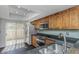 Stylish kitchen with stainless steel appliances, wood cabinetry, and access to the outdoor balcony at 13794 Marseilles Ct, Clearwater, FL 33762