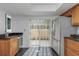 Kitchen featuring stainless steel appliances and access to a lovely outdoor balcony at 13794 Marseilles Ct, Clearwater, FL 33762