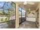 Relaxing lanai with two ceiling fans and attractive stone flooring at 13794 Marseilles Ct, Clearwater, FL 33762
