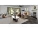 Cozy living room showcasing hardwood floors, comfortable seating, fireplace, and sun-filled windows at 13794 Marseilles Ct, Clearwater, FL 33762