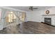 Bright living room with wood-look tile, fireplace, and sliding glass doors to the outdoor patio at 13794 Marseilles Ct, Clearwater, FL 33762