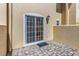 Charming patio with brick pavers, exterior light and sliding glass doors at 13794 Marseilles Ct, Clearwater, FL 33762