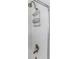 Close-up of shower with bronze fixture, shower caddy and white tiled wall at 13794 Marseilles Ct, Clearwater, FL 33762