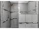 Modern shower with gray tile and glass door at 13794 Marseilles Ct, Clearwater, FL 33762