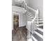 Bright foyer featuring a staircase with white wood railings, dark wood treads and hardwood floors at 13794 Marseilles Ct, Clearwater, FL 33762