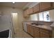 Kitchen featuring stainless steel sink, white appliances and wooden cabinets at 5602 Pinnacle Heights Cir # 209, Tampa, FL 33624