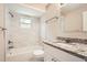 Updated bathroom with granite countertop, shower, and marble tile at 7001 Heath Dr, Port Richey, FL 34668