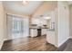 Open concept kitchen features granite countertops, white cabinets and luxury vinyl plank flooring at 7001 Heath Dr, Port Richey, FL 34668