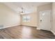 Bright living room features neutral walls, updated ceiling fan and luxury vinyl plank flooring at 7001 Heath Dr, Port Richey, FL 34668