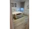 Serene bedroom featuring neutral decor and wood-look floors, creating a calming atmosphere at 1830 San Silvestro Dr, Venice, FL 34285