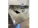 Kitchen featuring light granite countertops, white cabinetry, and modern appliances at 1830 San Silvestro Dr, Venice, FL 34285