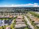 A beautiful aerial view of a residential neighborhood with houses, lakes and lush landscaping at 4949 Sandy Glen Way, Wimauma, FL 33598