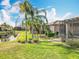 Expansive backyard with mature landscaping and a screened lanai at 4949 Sandy Glen Way, Wimauma, FL 33598