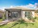 Picturesque backyard with a screened lanai and meticulous landscaping at 4949 Sandy Glen Way, Wimauma, FL 33598