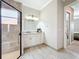 Bathroom featuring a glass shower, double sinks, and white cabinetry at 4949 Sandy Glen Way, Wimauma, FL 33598