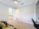 Neutral bedroom featuring a ceiling fan and easy access to an attached bathroom at 4949 Sandy Glen Way, Wimauma, FL 33598