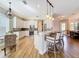 Open kitchen featuring white cabinetry, granite countertops, stainless steel appliances, and a breakfast bar at 4949 Sandy Glen Way, Wimauma, FL 33598