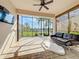 Open patio with ceiling fan, pavers and exterior view of palm trees and community at 4949 Sandy Glen Way, Wimauma, FL 33598
