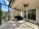 Covered patio provides a relaxing outdoor living space with an adjacent interior living area at 4949 Sandy Glen Way, Wimauma, FL 33598
