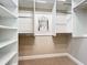 Spacious walk-in closet featuring built-in shelving and storage for accessories at 4949 Sandy Glen Way, Wimauma, FL 33598
